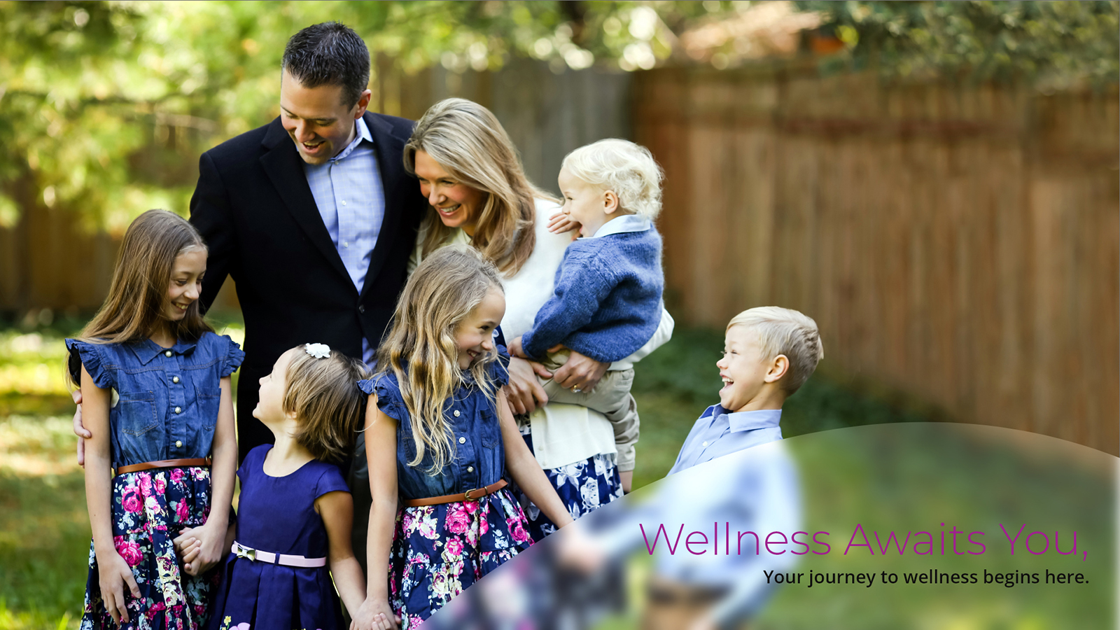 Banner for Newhouse Health Solutions featuring Dr. Patrick Newhouse, B.S, D.C. with his family in a spacious backyard area. The text on the bottom of the image reads 'Wellness Awaits You. Your journey to wellness begins here.'